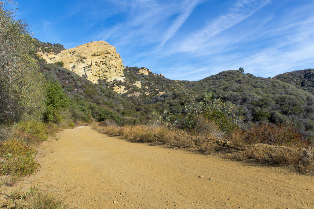 photo of dry hills of Los Angeles with path and brush.